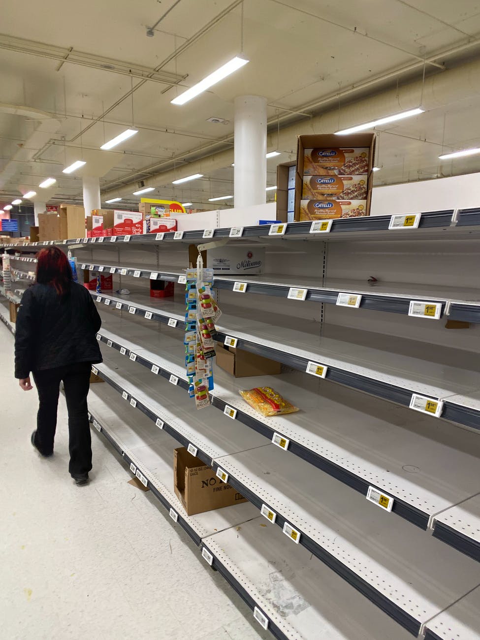 person walking on empty aisle on grocery store