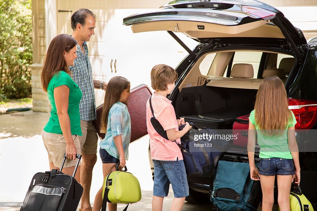 Family packing the car to evacuate to  safety