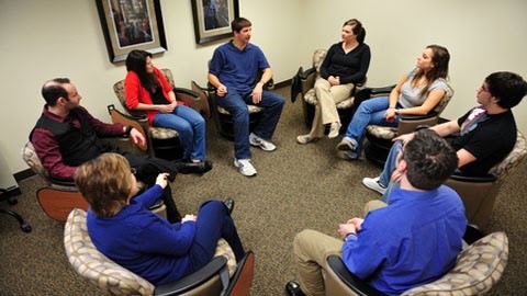 Group therapy session helping survivors of an active shooter