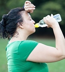 Woman drinking water during extreme heat
