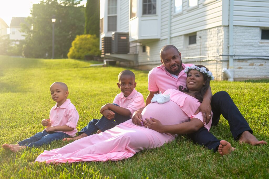 Pregnant couple and their two children. Life insurance can ensure their financial future. 